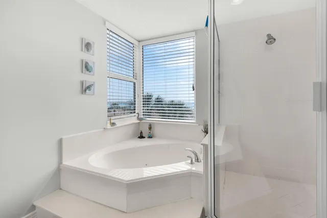 a bathroom with a bathtub and a shower
