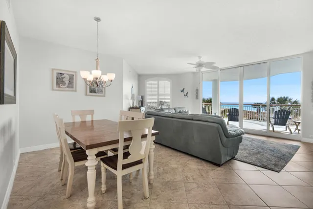 a living room with kitchen island furniture and a chandelier