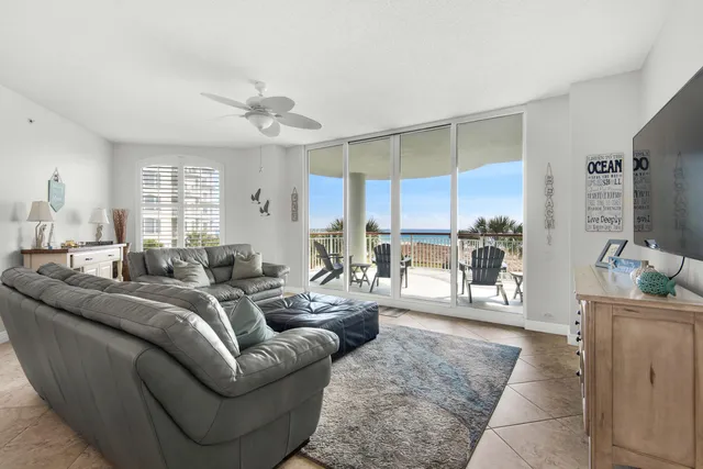 a living room with furniture wooden floor and a large window