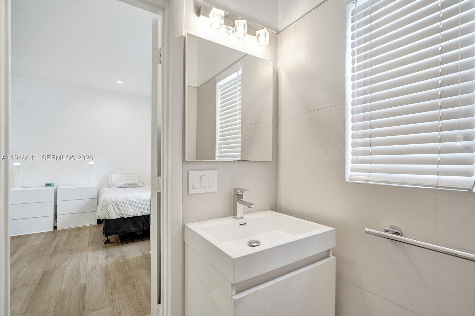 3757 Prairie Avenue Miami Beach, FL 33140 - Photo 14 of 19 a en suite bathroom with a sink and a mirror