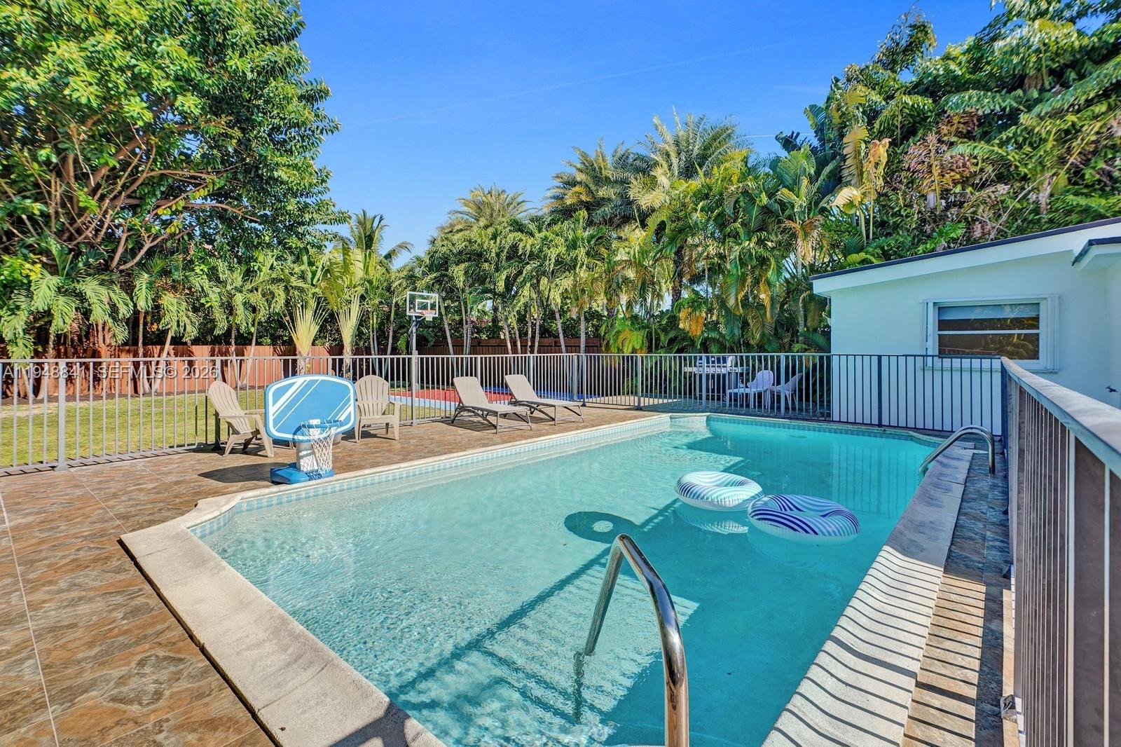 3757 Prairie Avenue Miami Beach, FL 33140 - Photo 2 of 19 a view of a swimming pool with a patio and fire pit