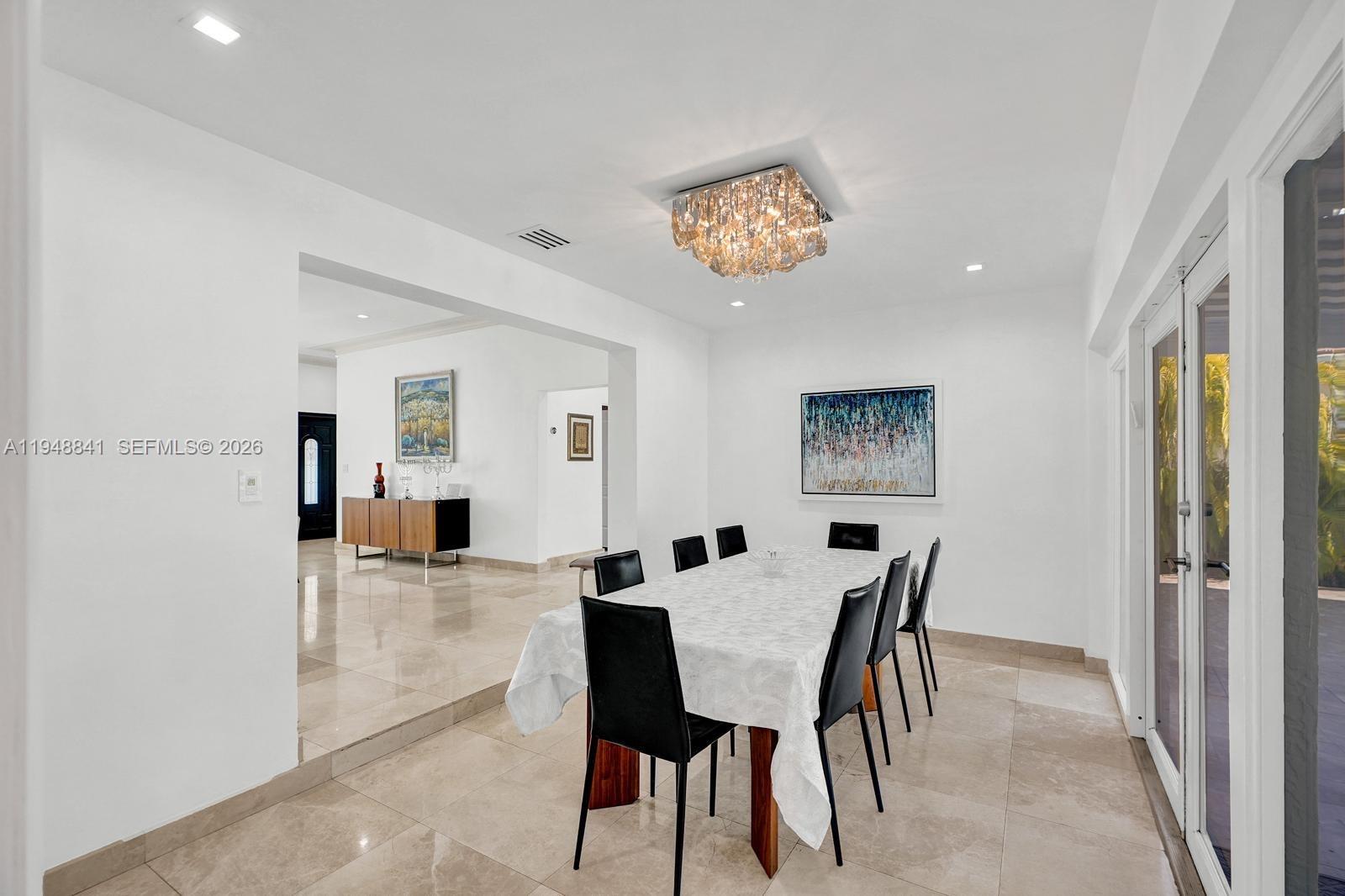3757 Prairie Avenue Miami Beach, FL 33140 - Photo 8 of 19 a view of a dining room with furniture and a chandelier