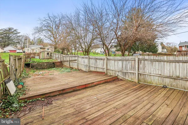 a view of a house with wooden fence