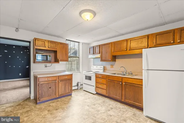 a kitchen with stainless steel appliances granite countertop a stove and a refrigerator
