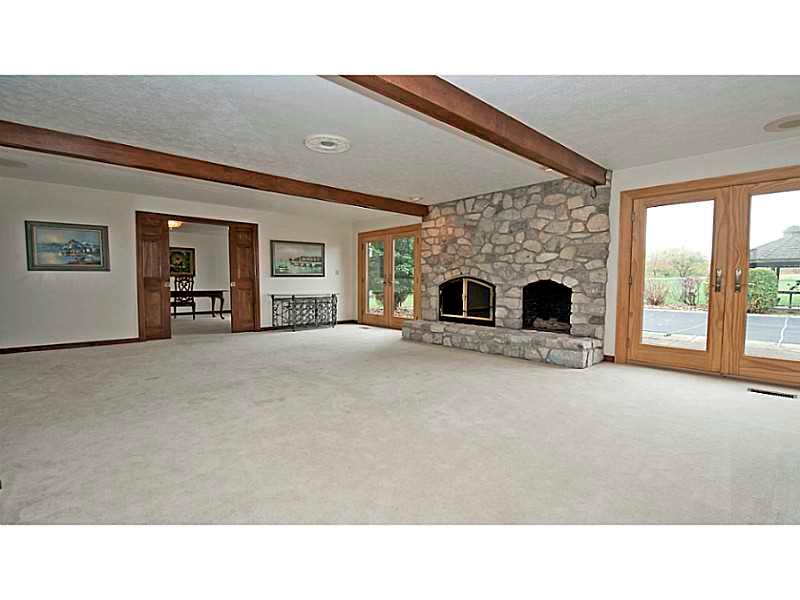 346 Germain Road Wexford, PA 15090 - Photo 4 of 20 Family Room. Family room is showcased by a stone fireplace and wood ceiling beams and easily access to the pool area.