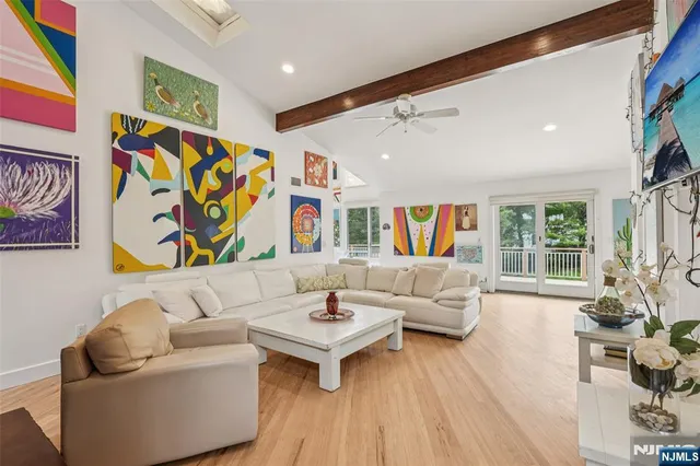 a living room with fireplace furniture and a wooden floor