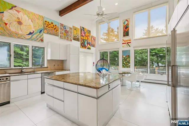 a kitchen with a sink and living room