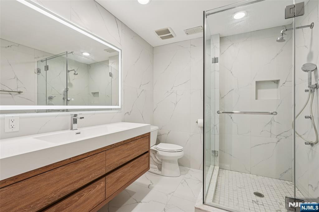 16 Schaffer Road Alpine, NJ 07620 - Photo 19 of 25 a bathroom with a sink a toilet and shower