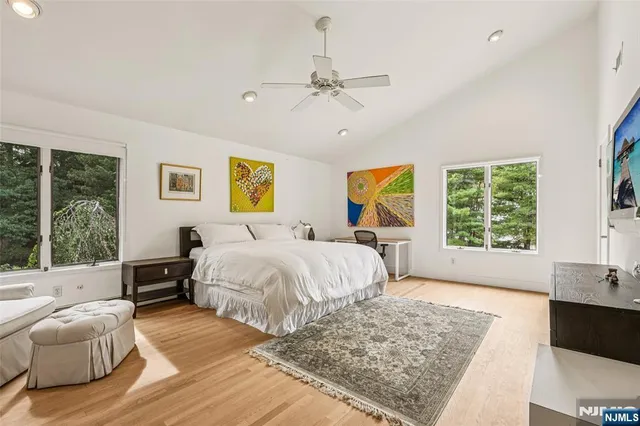 a spacious bedroom with a large bed and a window