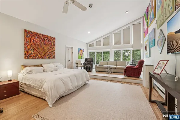 a bedroom with a large bed couch and a window