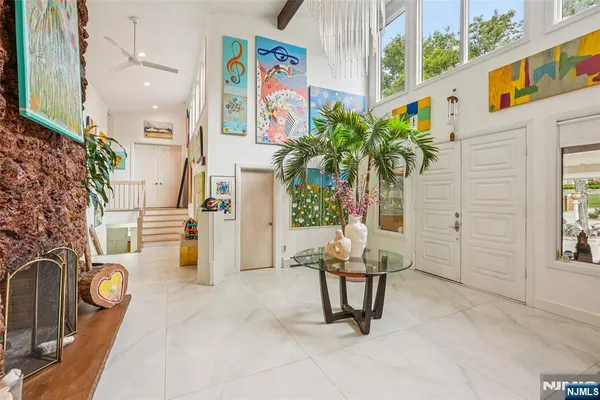 a living room with patio furniture and a potted plant