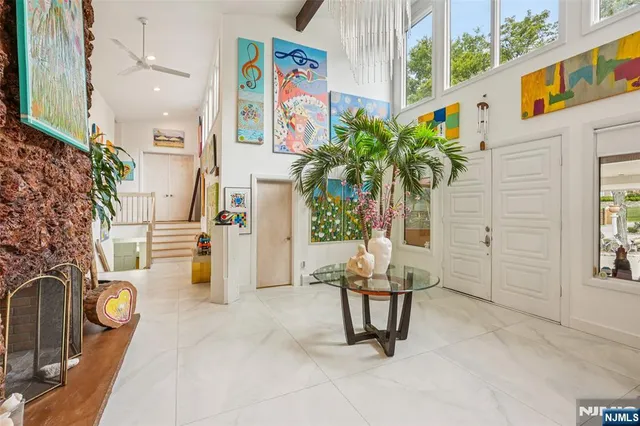 a living room with patio furniture and a potted plant