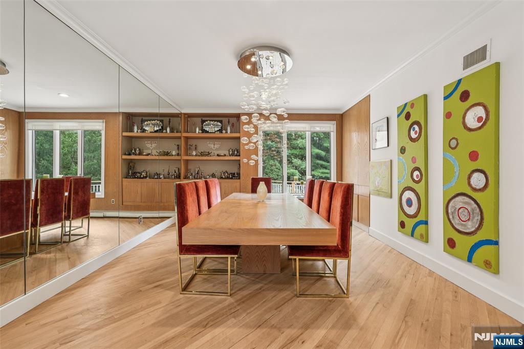 16 Schaffer Road Alpine, NJ 07620 - Photo 5 of 25 a view of a dining room with furniture a chandelier and wooden floor