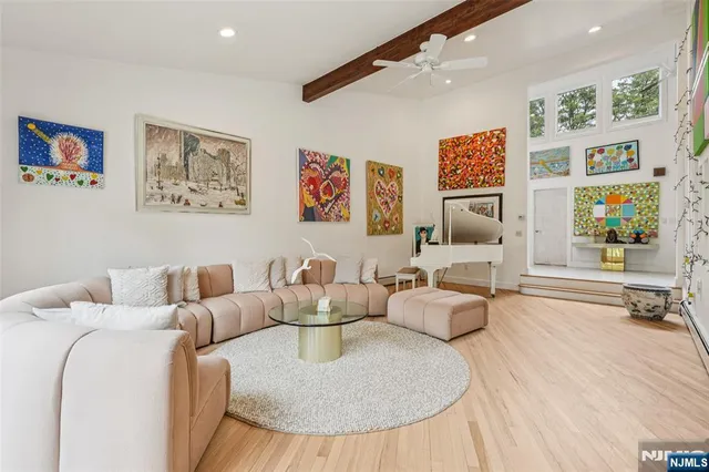 a living room with furniture and painting on the wall