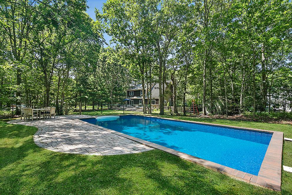 34 Old Fish Cove Road Southampton, NY 11968 - Photo 2 of 17 a view of a backyard with swimming pool