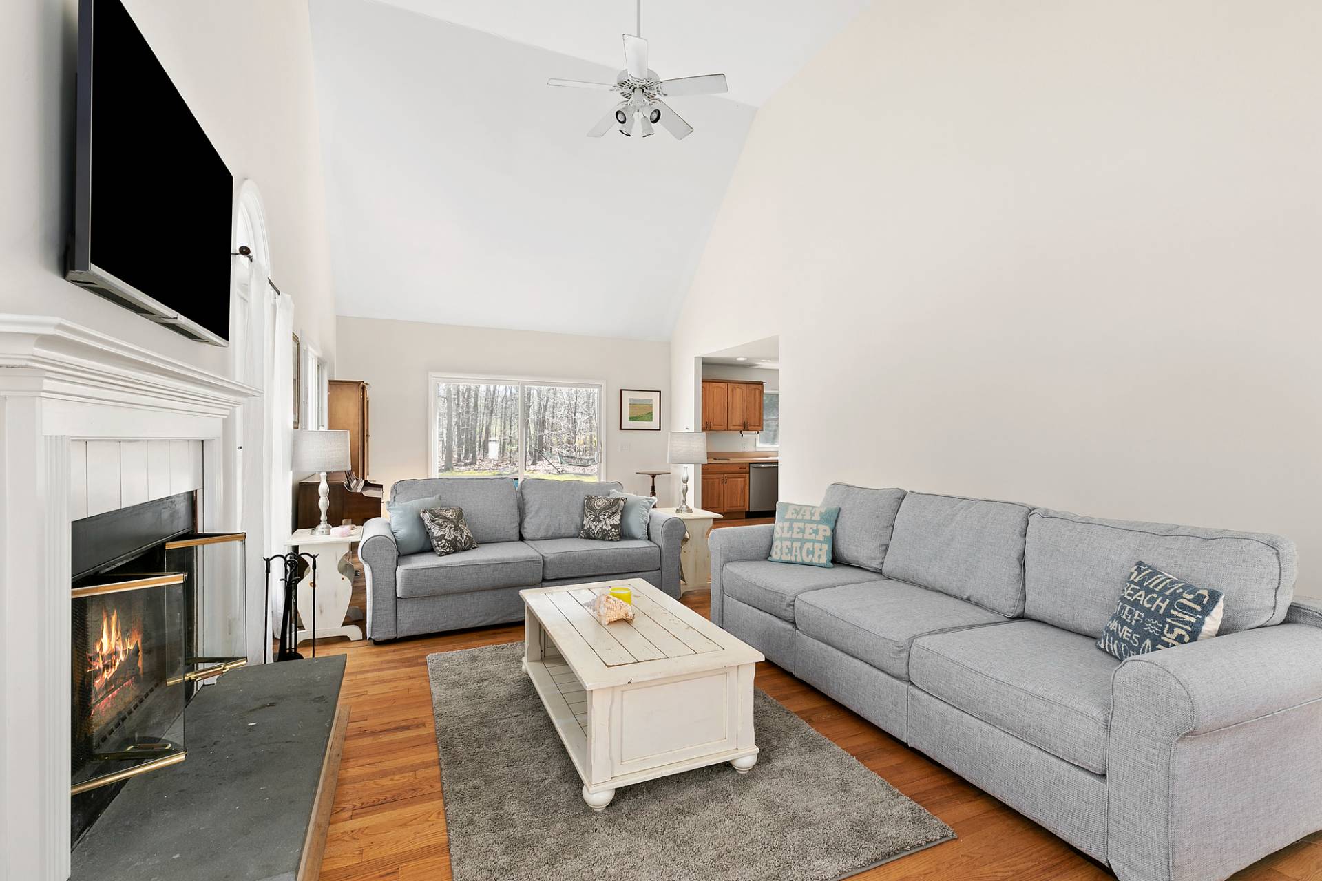 34 Old Fish Cove Road Southampton, NY 11968 - Photo 5 of 17 a living room with furniture a flat screen tv and a fireplace