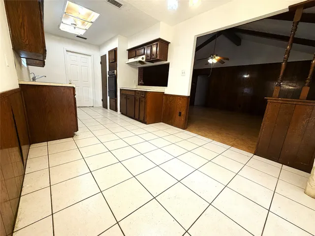 a kitchen with stainless steel appliances kitchen island wooden cabinets a sink and a counter top space