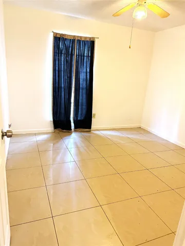 a view of an empty room with fan