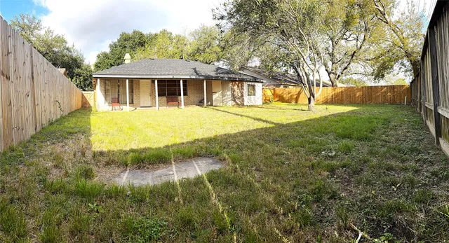 a backyard of a house with yard and outdoor seating