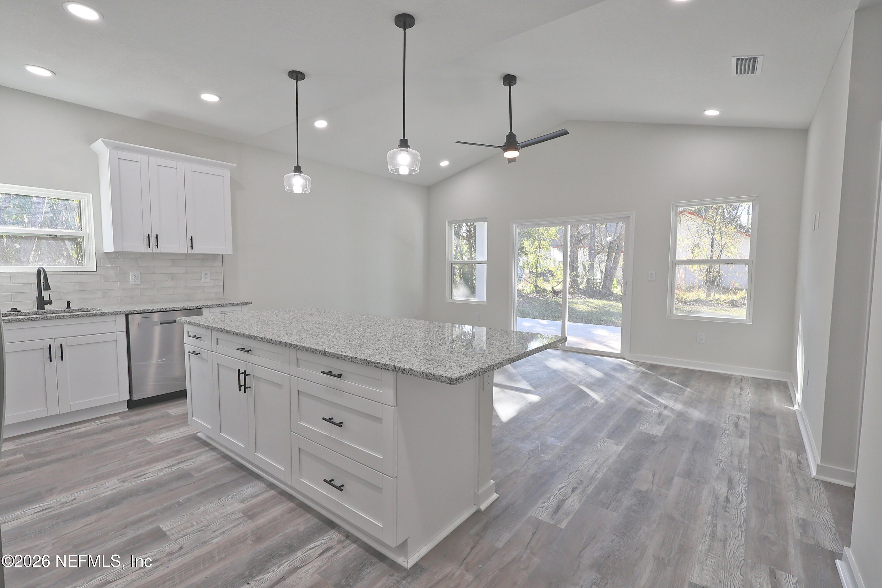 30 Delmonte Street Baldwin, FL 32234 - Photo 13 of 37 a open kitchen with kitchen island white cabinets and white appliances