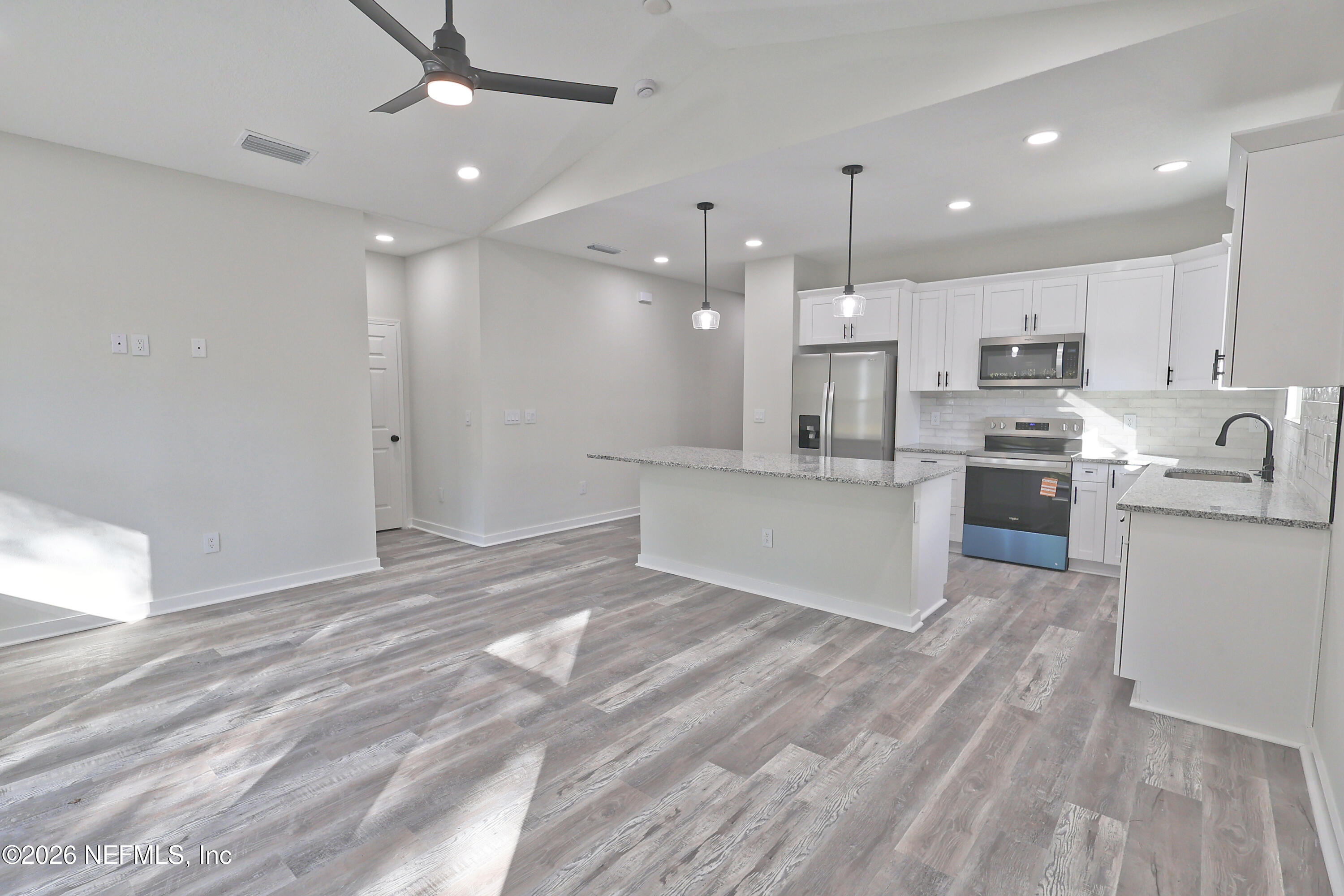 30 Delmonte Street Baldwin, FL 32234 - Photo 15 of 37 a view of kitchen with wooden floor and stainless steel appliances