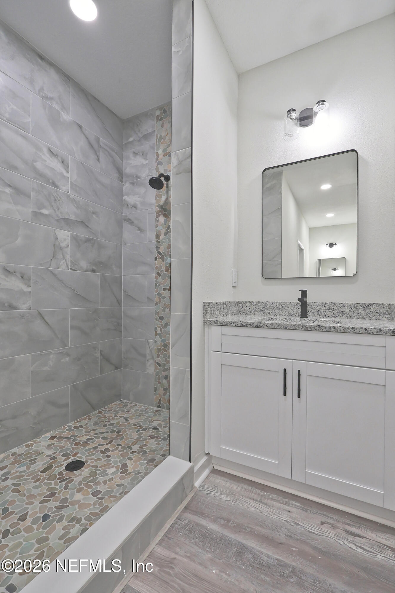 30 Delmonte Street Baldwin, FL 32234 - Photo 19 of 37 a bathroom with a granite countertop sink a mirror and shower