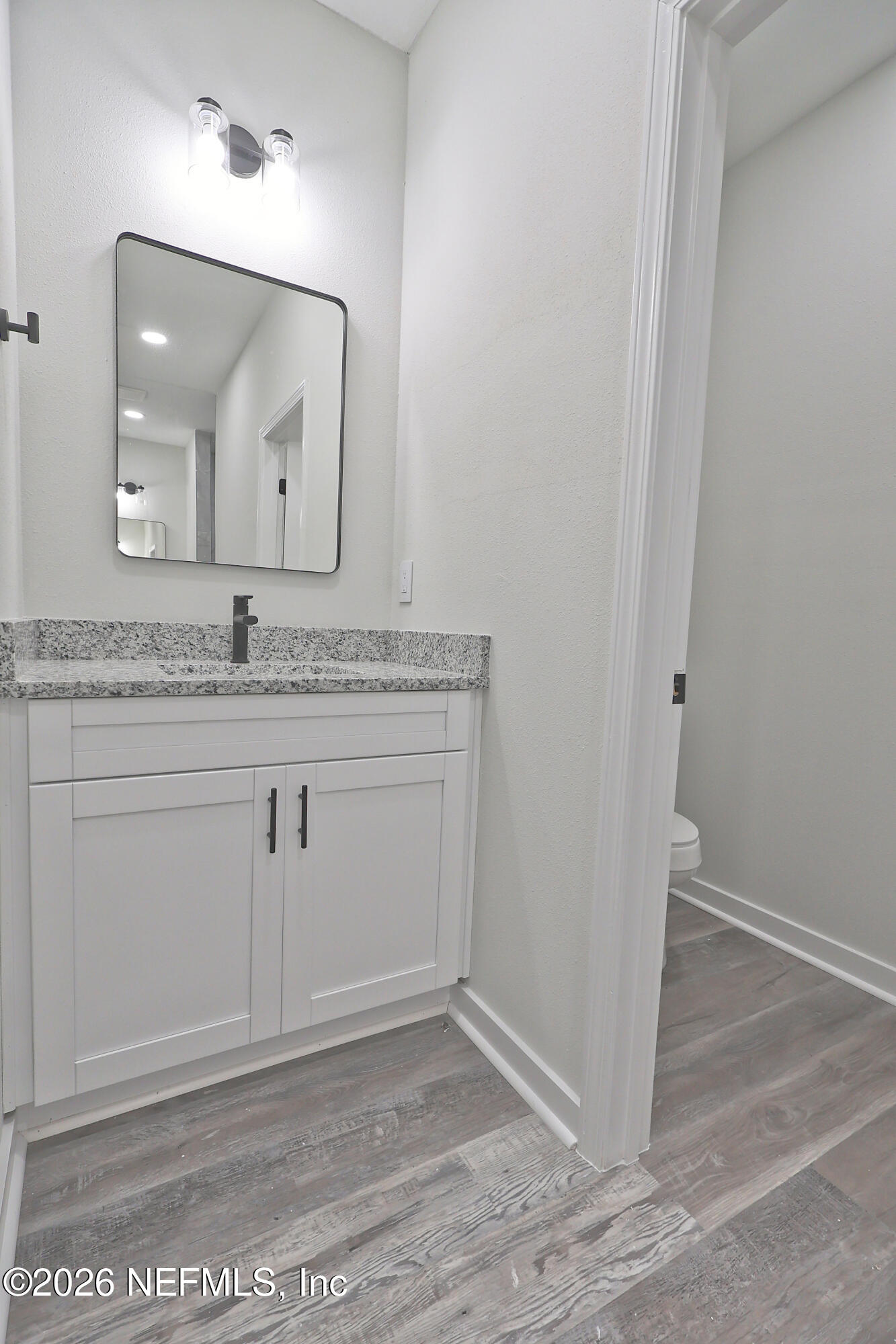 30 Delmonte Street Baldwin, FL 32234 - Photo 23 of 37 a bathroom with a granite countertop sink and a mirror
