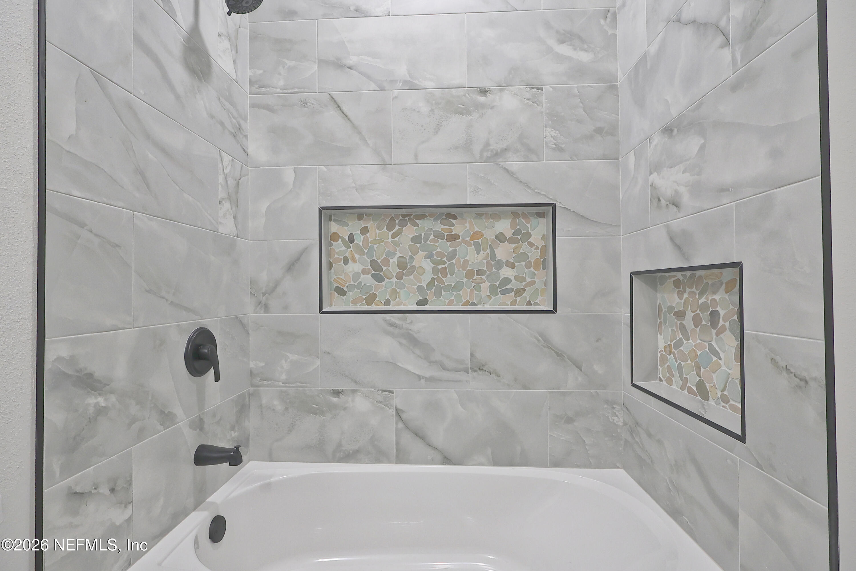 30 Delmonte Street Baldwin, FL 32234 - Photo 30 of 37 a bathroom with bathtub and shower