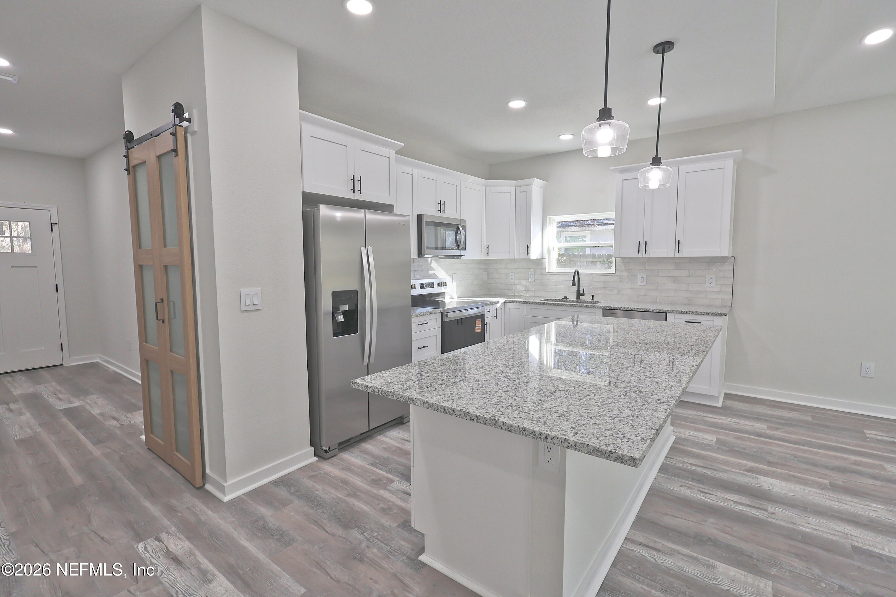 30 Delmonte Street Baldwin, FL 32234 - Photo 7 of 37 a kitchen with stainless steel appliances granite countertop a refrigerator a sink a stove and a refrigerator