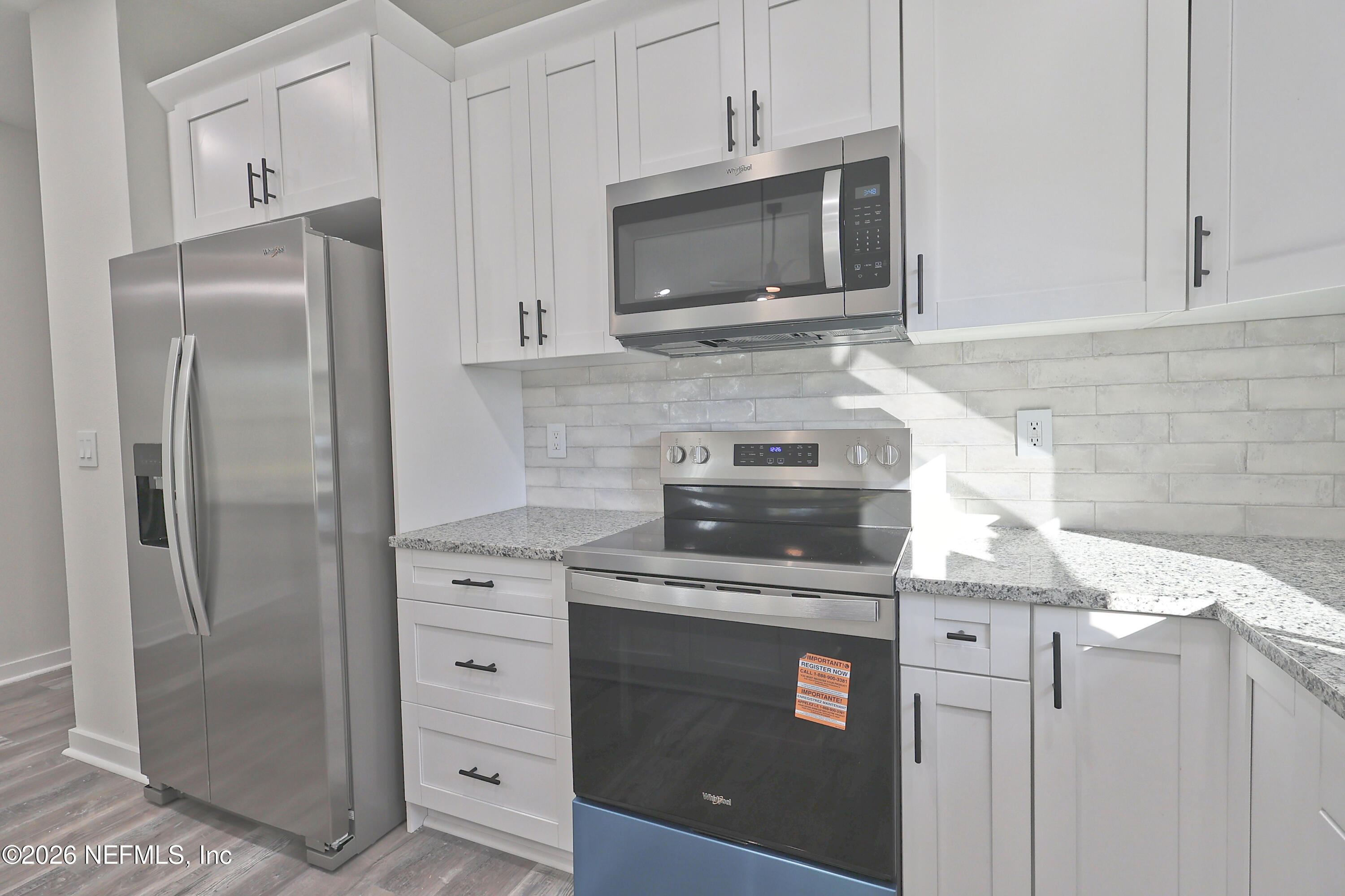 30 Delmonte Street Baldwin, FL 32234 - Photo 10 of 37 a kitchen with stainless steel appliances granite countertop a refrigerator stove and microwave