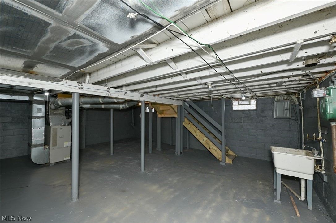 77 West Mildred Avenue Akron, OH 44310 - Photo 40 of 40 Unfinished basement with stairs and heating unit