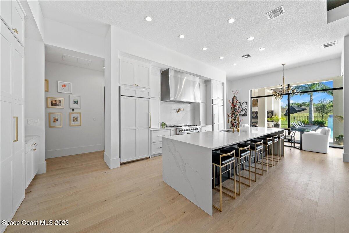 3022 BELLWIND Circle Rockledge, FL 32955 - Photo 12 of 46 a kitchen with stainless steel appliances kitchen island granite countertop a refrigerator and a stove top oven