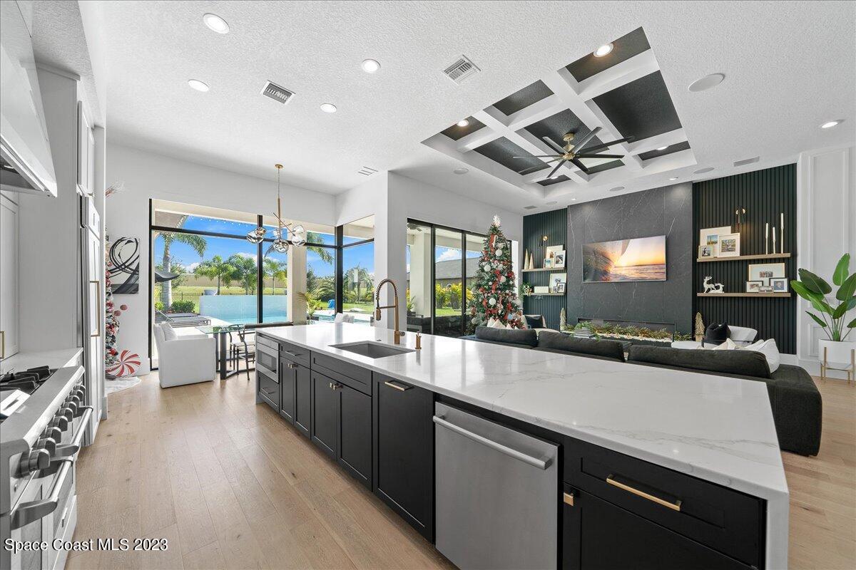 3022 BELLWIND Circle Rockledge, FL 32955 - Photo 13 of 46 a large kitchen with stainless steel appliances a large counter top a stove a chimney a sink and a large window