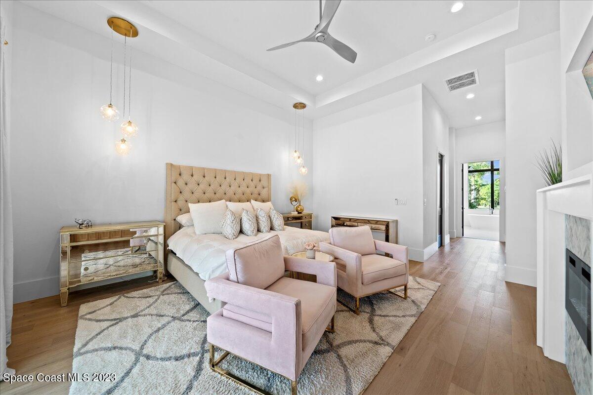 3022 BELLWIND Circle Rockledge, FL 32955 - Photo 19 of 46 a bed room with a bed a couch and a chandelier