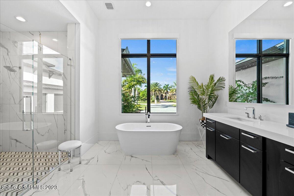 3022 BELLWIND Circle Rockledge, FL 32955 - Photo 20 of 46 a spacious bathroom with a granite countertop sink and a mirror