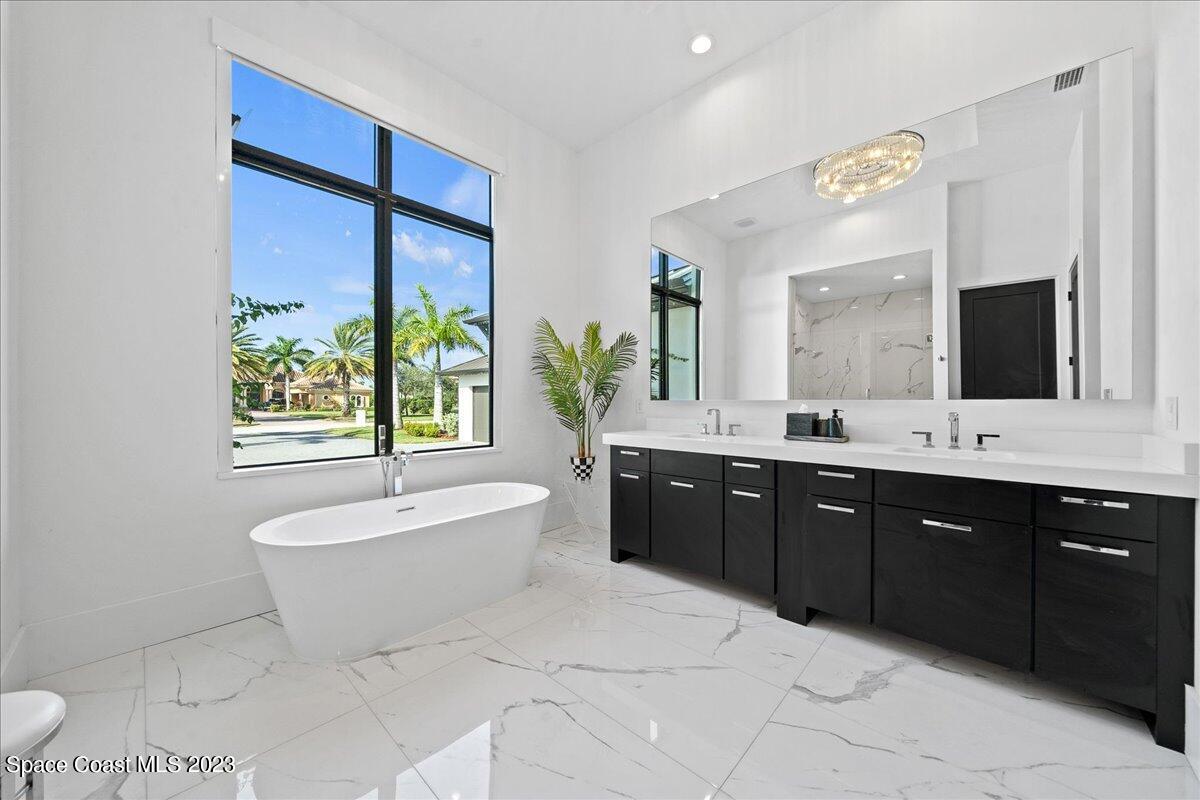 3022 BELLWIND Circle Rockledge, FL 32955 - Photo 21 of 46 a spacious bathroom with a tub sink and mirror