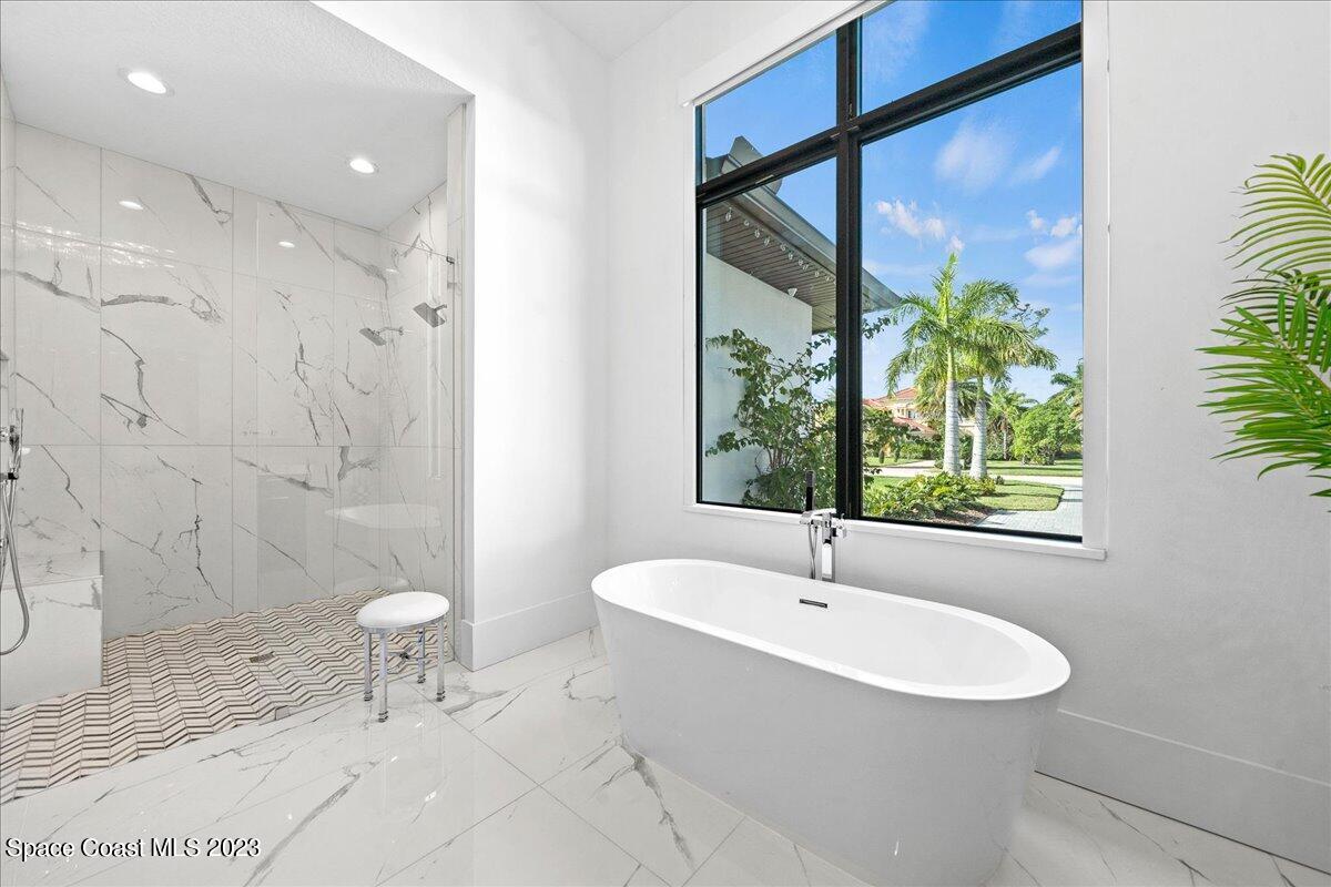 3022 BELLWIND Circle Rockledge, FL 32955 - Photo 22 of 46 a bathroom with a sink toilet a mirror and shower