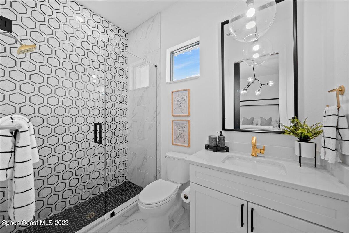 3022 BELLWIND Circle Rockledge, FL 32955 - Photo 25 of 46 a bathroom with a sink mirror vanity and toilet