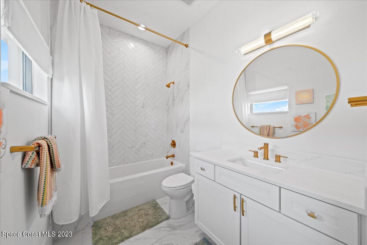 3022 BELLWIND Circle Rockledge, FL 32955 - Photo 29 of 46 a bathroom with a sink a toilet and a mirror