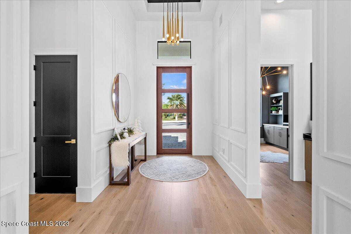 3022 BELLWIND Circle Rockledge, FL 32955 - Photo 3 of 46 a view of a hallway with wooden floor windows and a livingroom