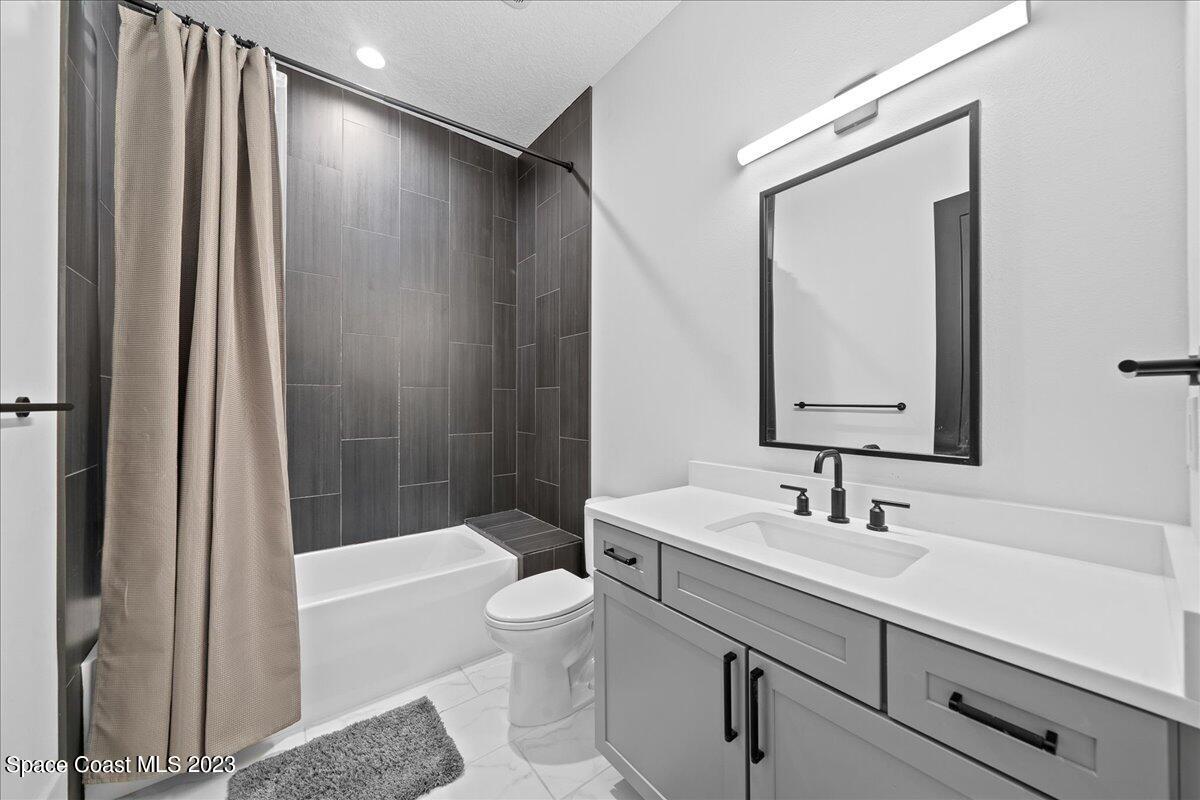 3022 BELLWIND Circle Rockledge, FL 32955 - Photo 31 of 46 a bathroom with a sink a toilet and shower