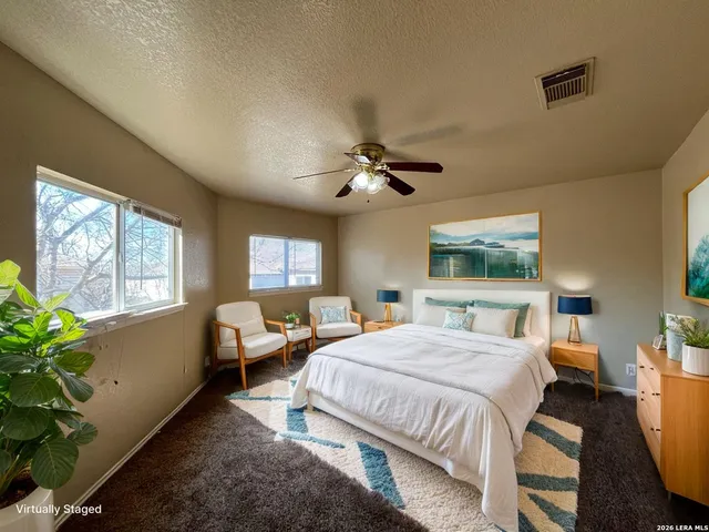 a bedroom with a bed couch and window