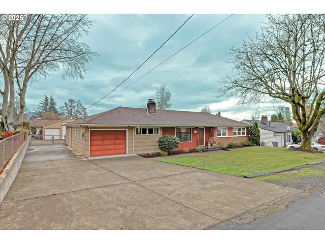 a view of a house with a yard and garage