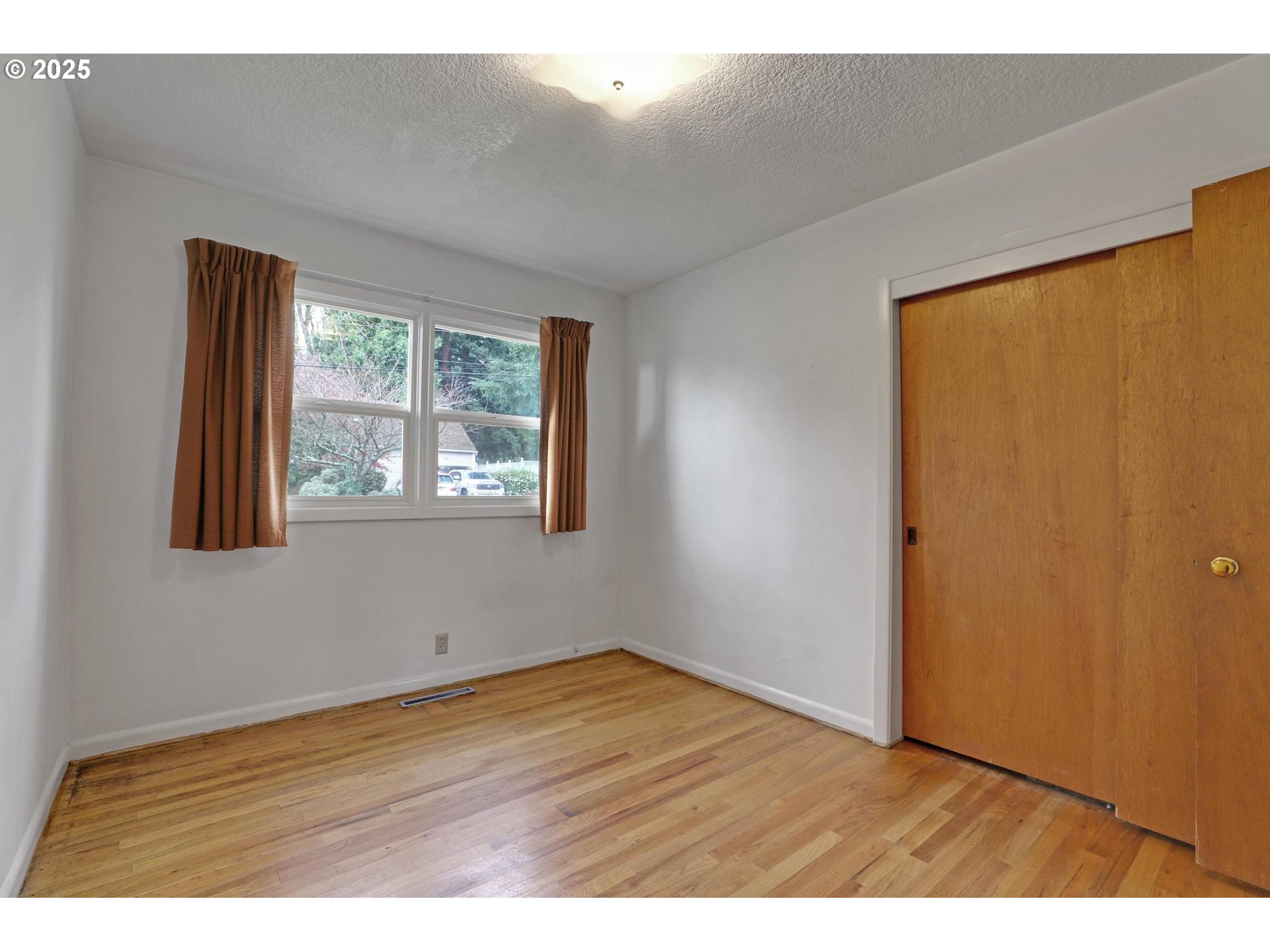 11500 Southwest 90th Avenue Portland, OR 97223 - Photo 15 of 30 a view of an empty room with wooden floor and a window