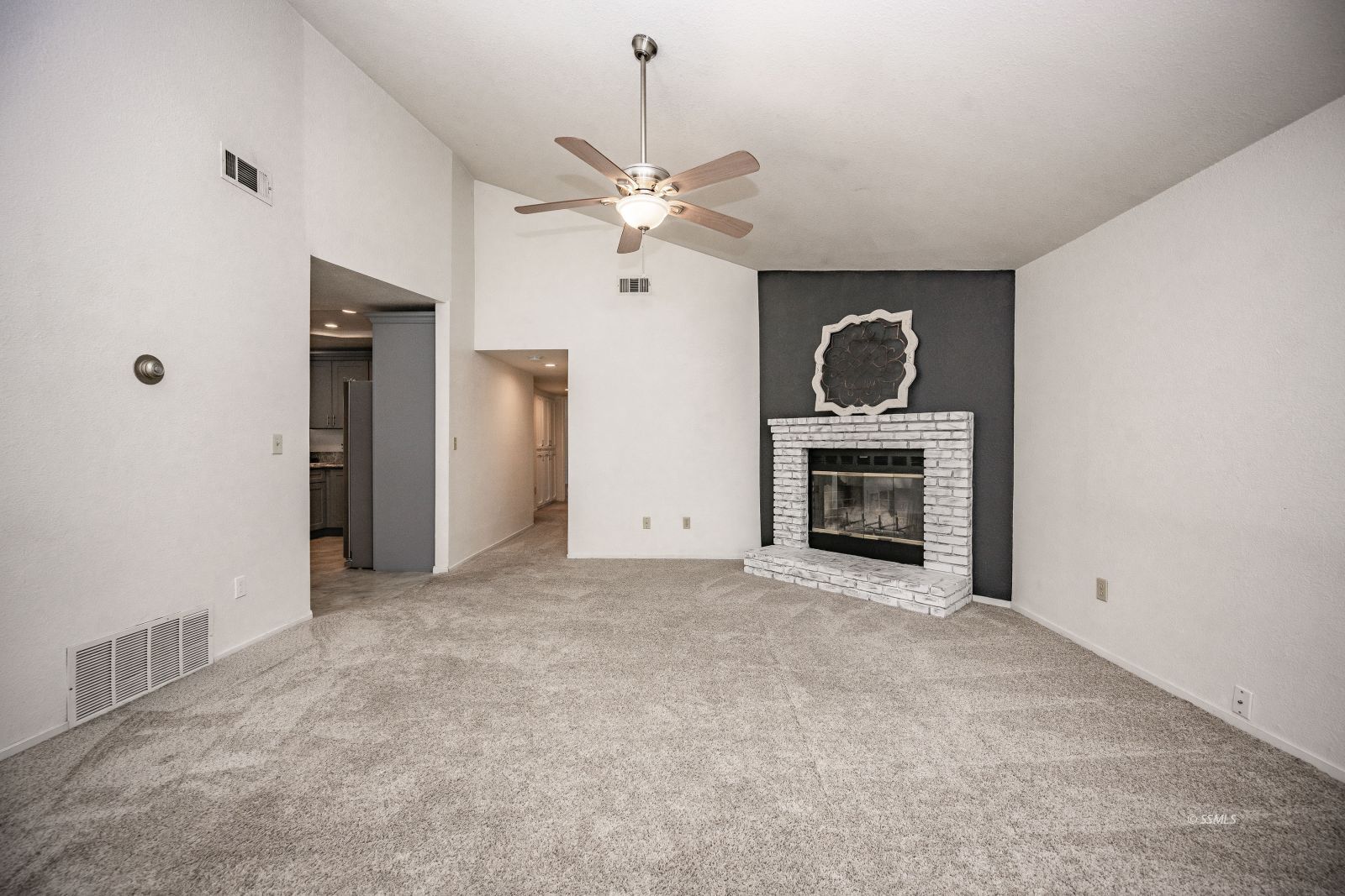 704 Beth Lane Ridgecrest, CA 93555 - Photo 17 of 39 a view of empty room with a fireplace