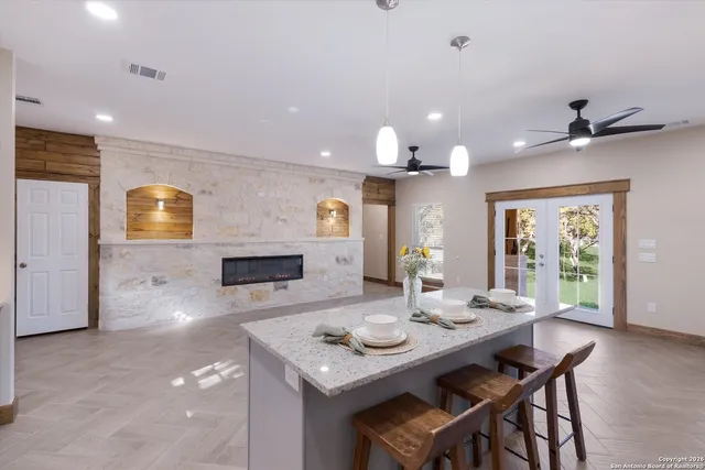 a view of a kitchen with a refrigerator and a ceiling fan