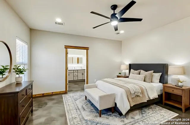 an empty room with windows and fan