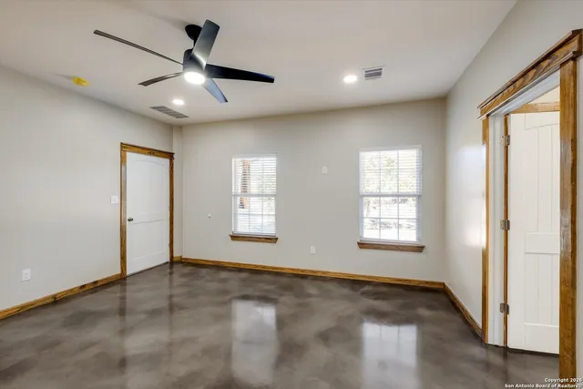 a spacious bathroom with a granite countertop sink toilet a large mirror and a bathtub