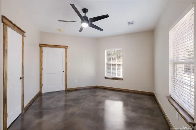 a bathroom with a granite countertop toilet a sink and a mirror