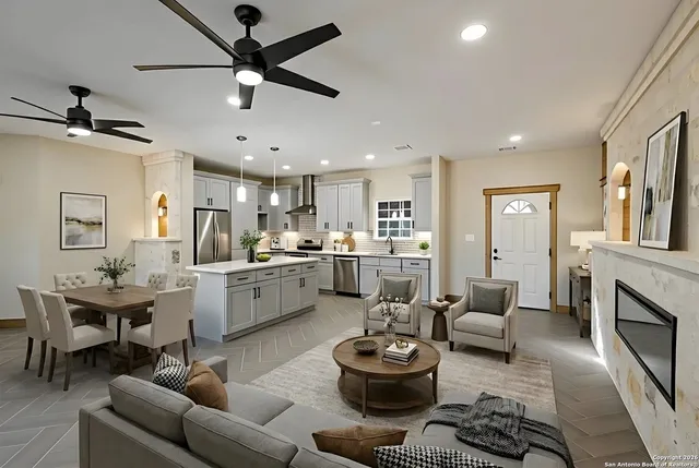 a large white kitchen with a window and stainless steel appliances